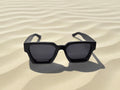 bushiribana black sunglasses on sand front view